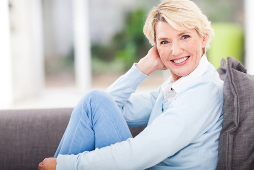 smiling woman sitting on couch