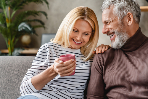 man and woman sitting on couch