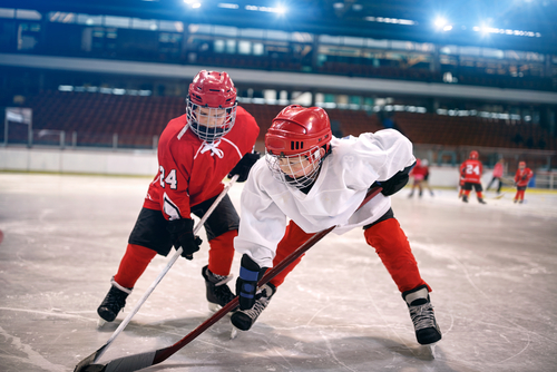 kids playing hockey while wearing eye safety protection 